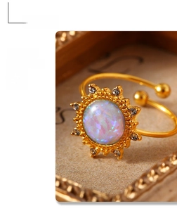Close-up of sunburst opal ring with crystals in a gold vintage frame setting