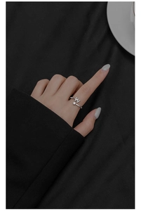 Close-up of S925 silver adjustable letter W ring with cubic zirconia on model finger