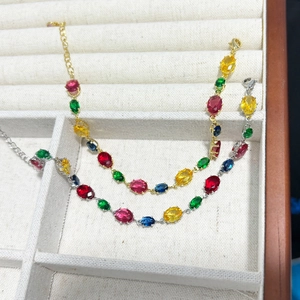 Detail of colorful crystal heart bracelets in gold and silver with lobster clasp