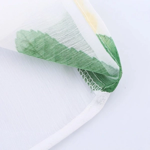 Blouse élégante en mousseline blanche à motif de feuilles vertes et manches lanternes