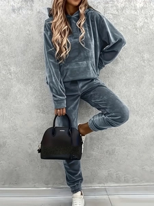 Detailed texture of velvet loungewear set featuring kangaroo pocket hoodie and joggers
