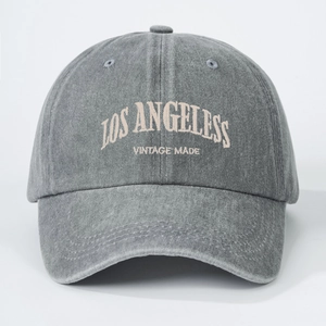Close-up of vintage washed gray baseball cap with Los Angeles embroidery and soft cotton texture