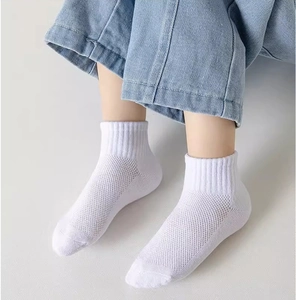 Close-up of white breathable mesh socks for kids showing detailed texture and rib cuff