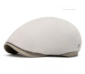 Detail of light gray canvas newsboy cap featuring khaki brim and side metal buckle