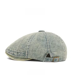 Side view of washed light blue denim beret cap featuring adjustable metal buckle and strap