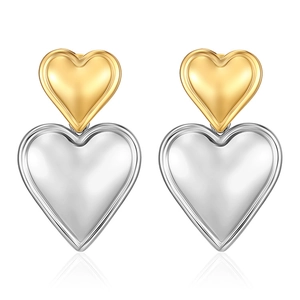 Detailed view of puffed heart-shaped earrings in two-tone gold and silver metallic finish