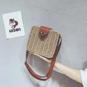 Fashionable handmade straw crossbody square bag with brown leather flap and bronze lock