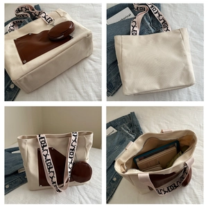 Detail view of large canvas tote bag with brown leather pocket and round coin purse accessory