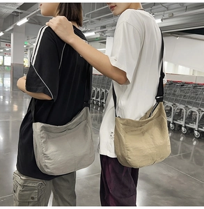 Close-up of lightweight nylon messenger bag showing durable texture and wide strap