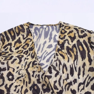 Deep V-neck animal print blouse in lightweight leopard mesh fabric with irregular pattern