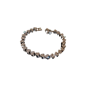 Elegant silver heart-shaped bracelet with full diamond inlay on a clean white background