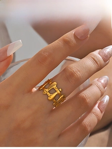 Macro detail of 18K gold plated stainless steel ring with modern liquid metal texture