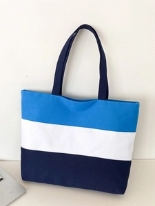 Detail of blue and white striped canvas tote bag showing the three-tone patchwork fabric