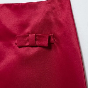 Elegant red satin Christmas two-piece set featuring a delicate bow detail on the top