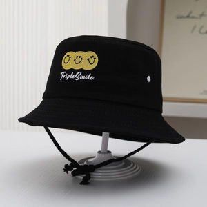Detail of black canvas bucket hat featuring triple smile embroidery and adjustable chin cord