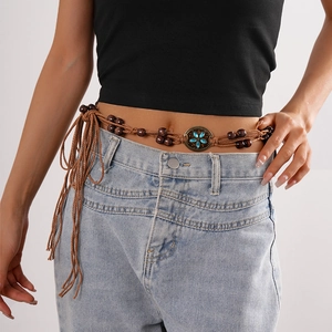 Detail of bohemian braided waist chain with dark wood beads and blue floral gemstones