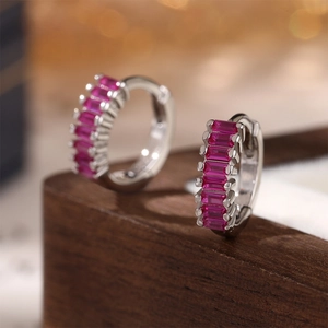 Detail view of 925 silver hoop earrings featuring rectangular rose red cubic zirconia stones