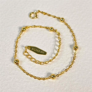 Macro shot of 925 sterling silver bead chain bracelet with gold finish and S925 hallmark