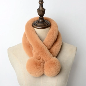 Detail of camel faux rabbit fur scarf with plush pom-poms on a professional mannequin