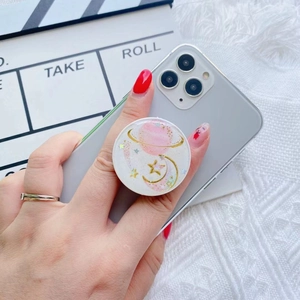 Detail of glitter starry galaxy phone grip with pink planet and moon epoxy decoration