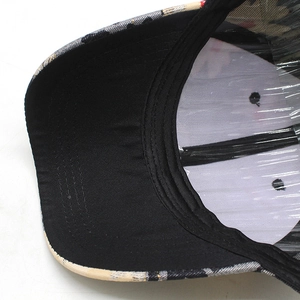 Detail showing inner structure of checkered baseball cap with stitching and plastic insert