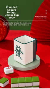 Detail view of Mahjong tile ceramic mug with green glazed handle and Fa character