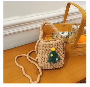 Detail of handmade khaki woven bag with green Christmas tree and yellow star