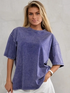Detail of vintage washed purple cotton T-shirt showing distressed fabric texture and silhouette