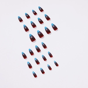 French stiletto press-on nails with deep red glossy base and light blue flame patterns
