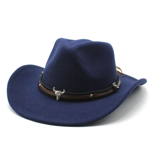 Close-up of navy wool western cowboy hat featuring leather band and silver bull skull detail