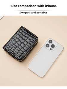 Close-up of black crocodile pattern wallet with double zippers compared to iPhone size