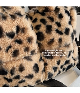 Close-up of soft leopard print faux fur texture and black nylon strap on tote bag