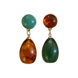 Retro resin drop earrings with asymmetric amber and green color contrast on white background