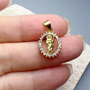 Detail of gold Jesus pendant with sparkling cubic zirconia border on stone background