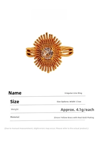 Detailed view of sunburst zircon ring in gold plated brass with irregular line texture