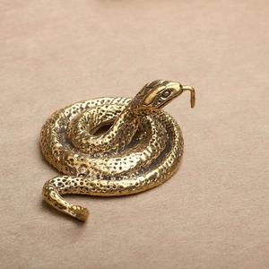 Macro detail of cobra snake brass figurine with realistic scales and vintage finish