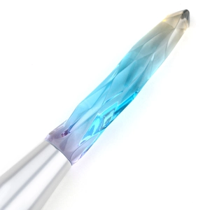 Detailed macro of crystal-textured faceted handle with colorful gradient and silver ferrule