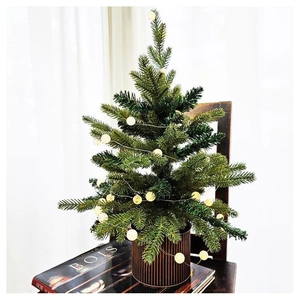 Mini Christmas tree with warm LED lights and ornaments in a striped metallic pot