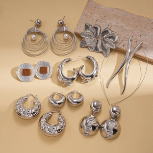 Chic silver geometric earrings collection featuring pearls, crystals, and hammered textures