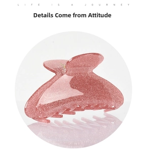 Close-up of pink glitter acrylic hair claw clip with a glossy translucent finish