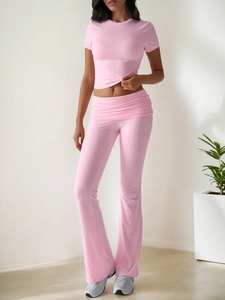 Front view of pink two-piece casual set with short crop top and high waist flared trousers