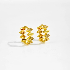 Macro shot of S925 hallmark on geometric gold earrings with cubic zirconia stones