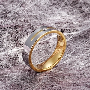 Detail of two-tone tungsten ring with brushed silver finish and inlaid round gemstone