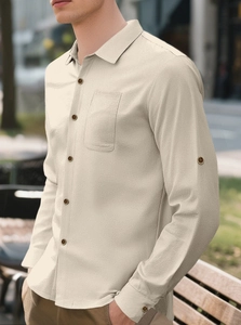 Detail of beige linen texture and wooden buttons on a men's casual short sleeve shirt