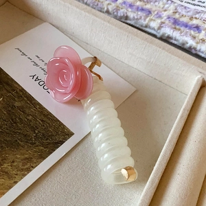 Close-up detail of the pink rose white telephone wire hair ring, chic sweet daily style.