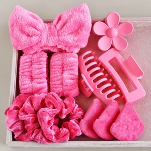 Detailed set of pink plush headbands, wristbands, makeup puffs, and matte hair claws