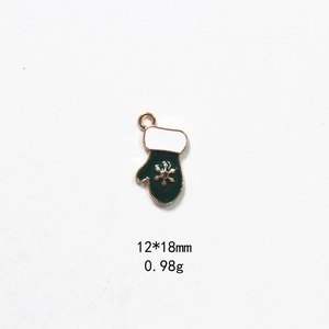 Detail of a green enamel Christmas glove pendant with a gold snowflake, 12x18mm size