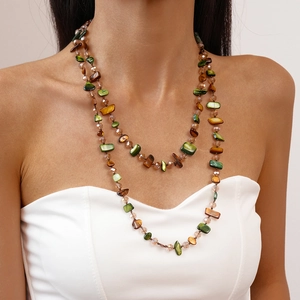 Close-up of double-layered necklace with brown and green irregular stone beads