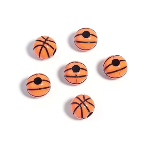 Detail of basketball acrylic beads with orange finish and black texture for DIY jewelry