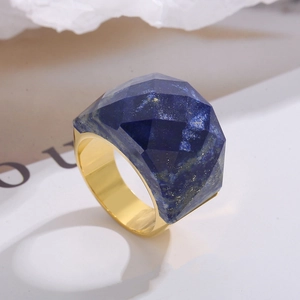 Macro detail of geometric faceted lapis lazuli stone set in 18K gold plated ring